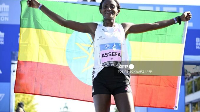 Ethiopia's Assefa breaking the women's marathon world record in Berlin